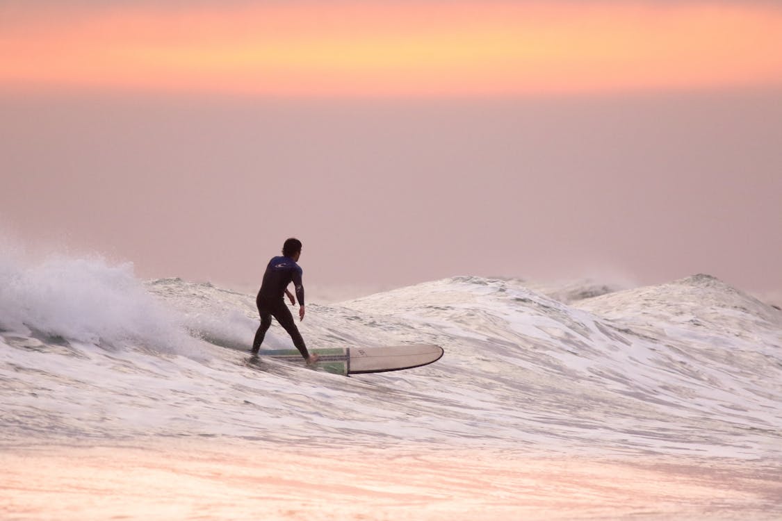 Man Doing Surfing at Golden Hour