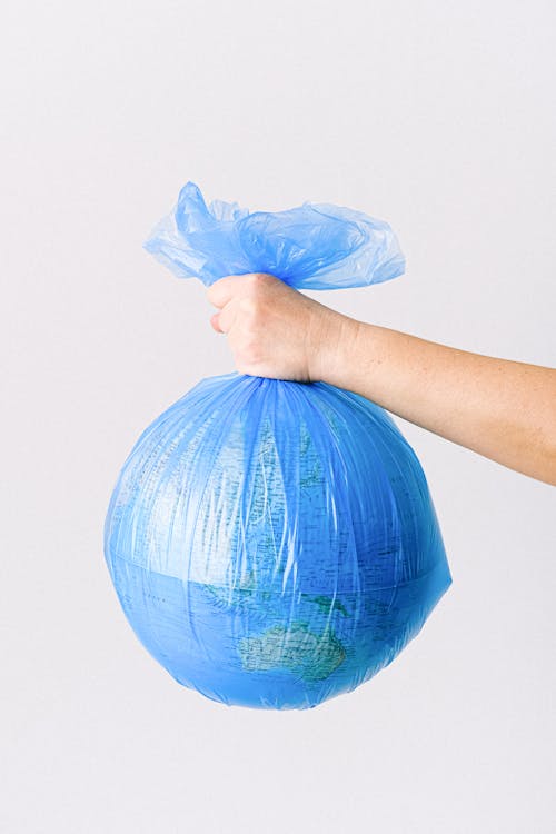 A Person Holding a Plastic Bag with a Globe