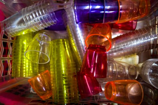 A vibrant top-down view of various colorful plastic cups stacked together, ideal for party settings.