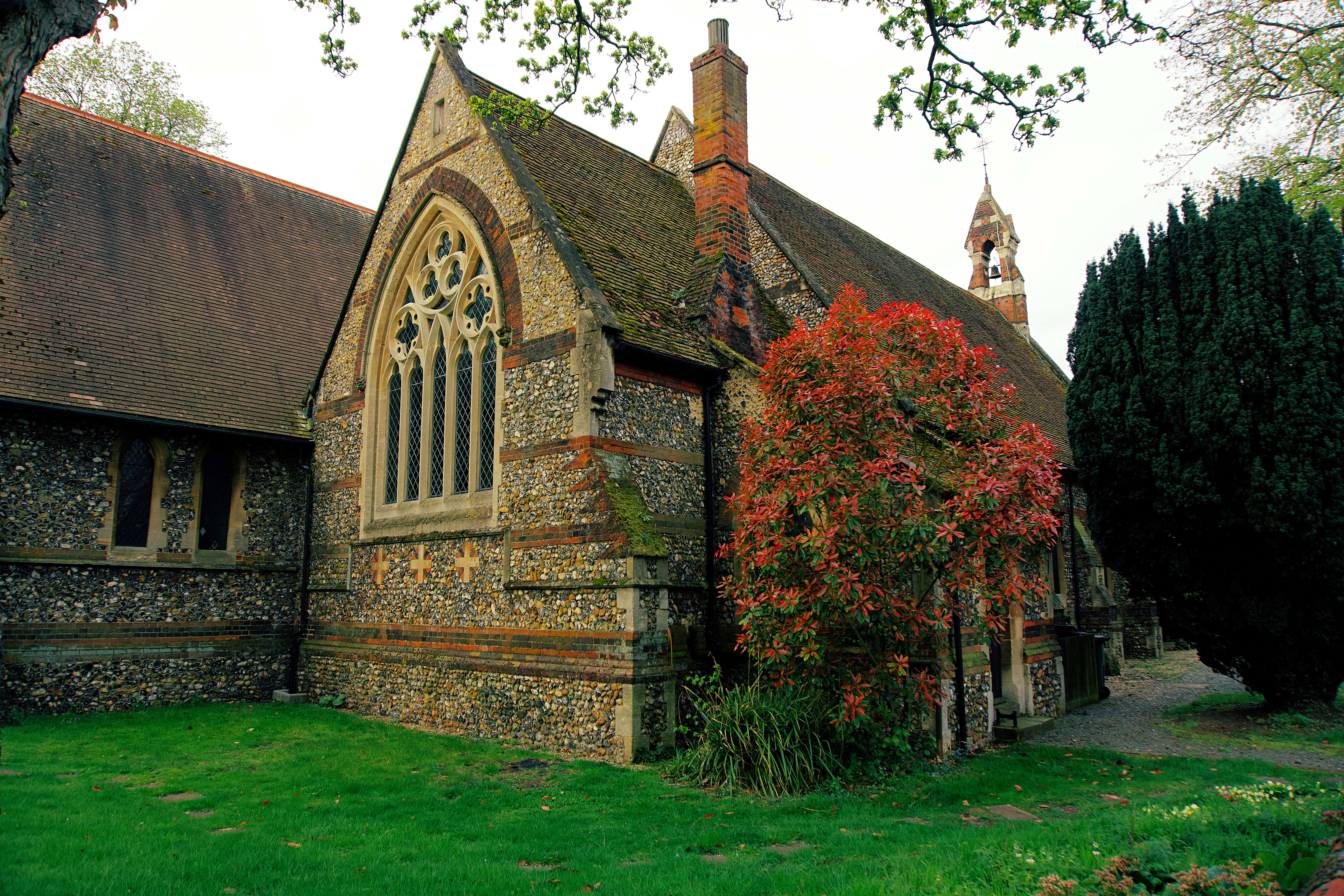 A picturesque stone church with Gothic architecture and lush surroundings in the United Kingdom.