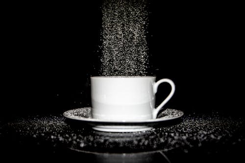 Close-Up Shot of Sugar Pouring into a White Cup