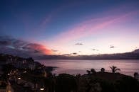 Town Beside Sea during Golden Hour