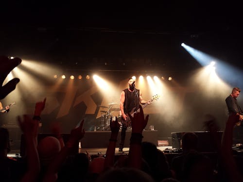 Person Playing Guitar on Stage