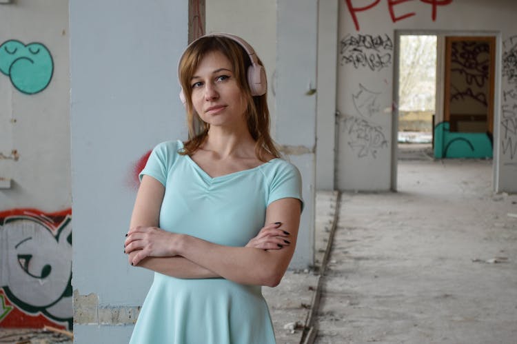 Serene Woman Listening To Song In Headset In Old Building