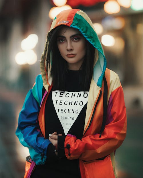 Trendy woman with TECHNO inscription on outfit on city street