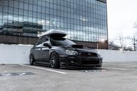 Modern sport car with rack on top parked on pavement