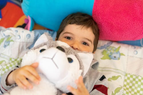 A Cute Boy Holding a Stuff Toy