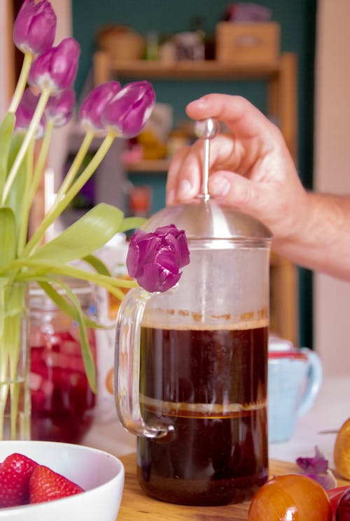 Free A Person Holding Clear Coffee Press Stock Photo