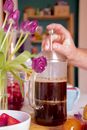 Person Holding Clear Glass Mug With Brown Liquid