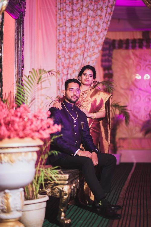 Free Couple posing together in traditional Indian clothing, indoors with a vibrant setting. Stock Photo