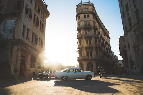 Free White Car Passing Thru Building Stock Photo