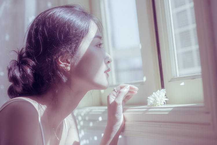 Sensual Asian Woman Looking Through Window