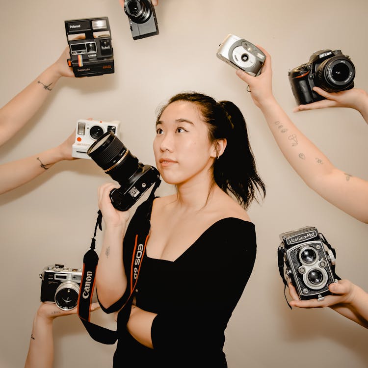 Asian Woman With Photo Camera In Hand