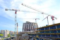 Red Crane Near High Rise Buildings