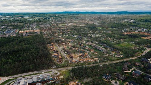 Free Aerial view of dramatic consequences of thunderstorm on town suburban district including damaged cottages and uprooted trees Stock Photo