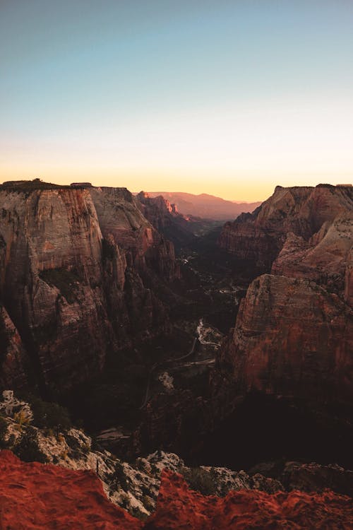 Scenic view of rough mountain slopes forming massive deep rocky ravine in highlands during picturesque sunset