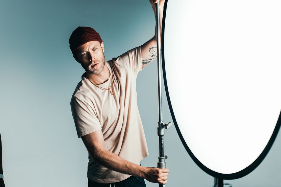 A photographer adjusting studio lights for a corporate headshot session - business headshots photography A photographer adjusting studio lights for a corporate headshot session - business headshots photography