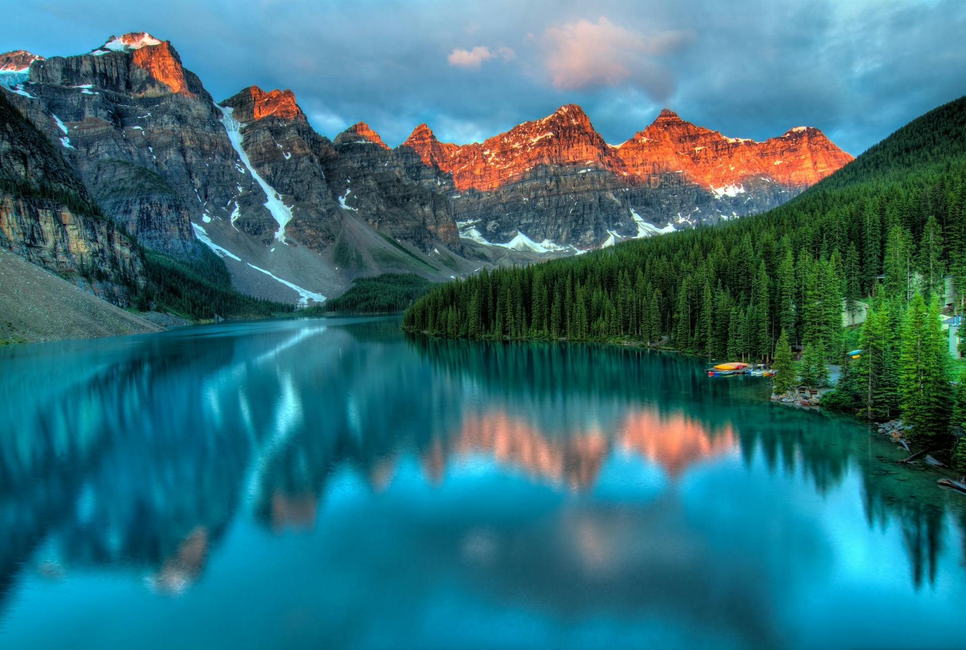 The serene beauty of Moraine Lake with sunrise reflections in Banff National Park
