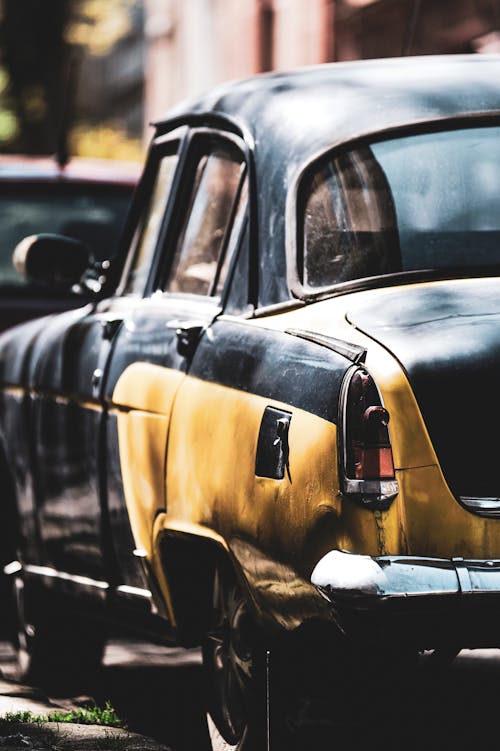 Retro taxi car parked on road in city