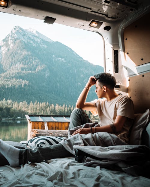 Free A Man Sitting Inside the Campervan Stock Photo
