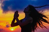 A serene moment of meditation with a vibrant sunset in the background, highlighting peace and spirituality.