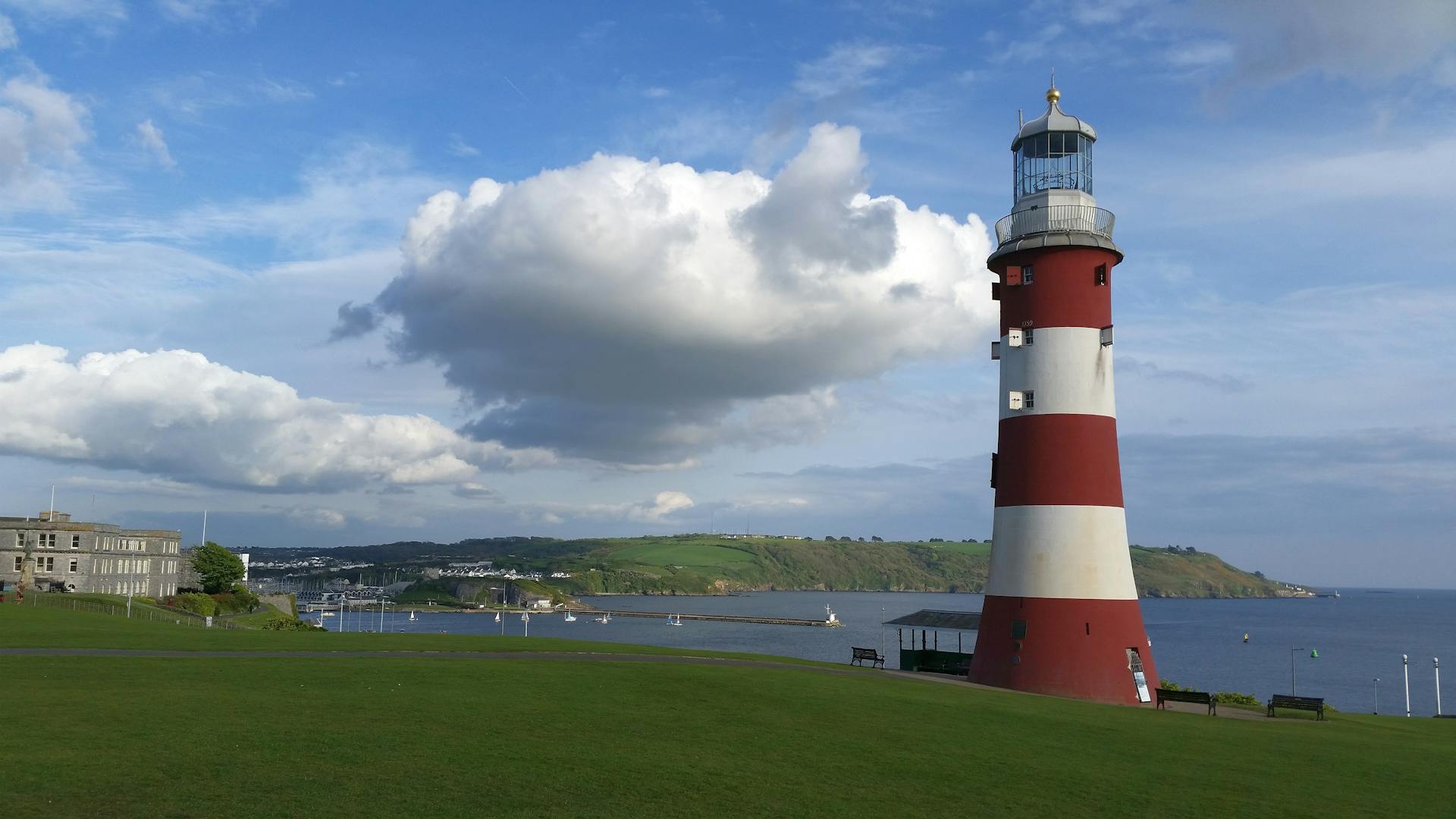 A scenic view of a lighthouse by the coast, highlighting its maritime charm and coastal beauty.