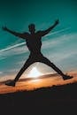 Silhouette of a Person Jumping during Sunset
