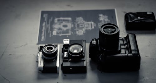 Retro photo cameras arranged on table