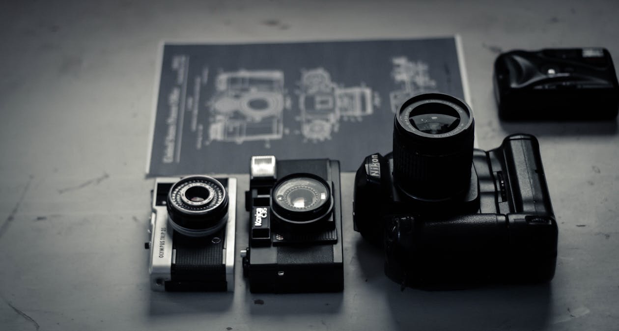 Retro photo cameras arranged on table