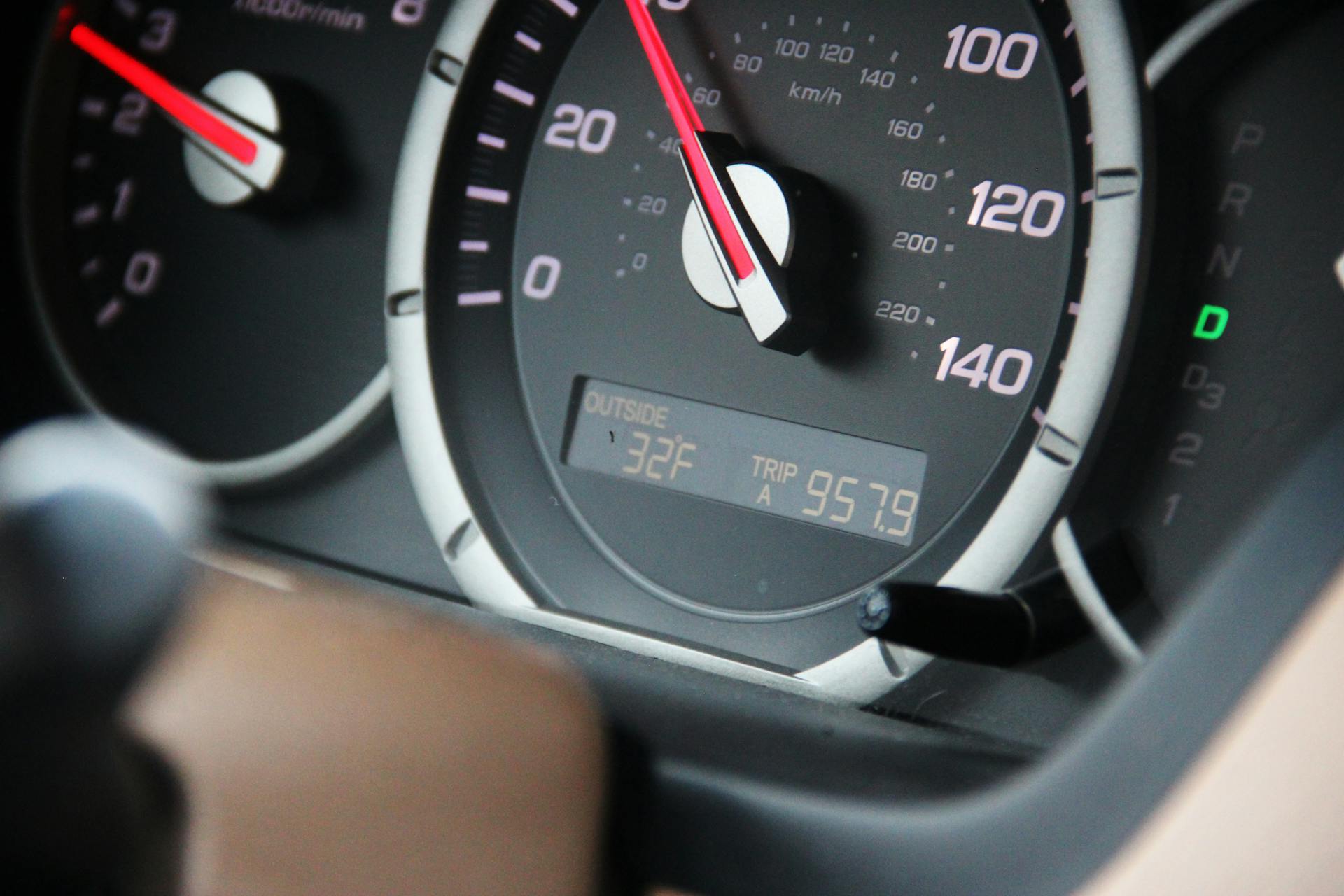 Detailed view of a car's speedometer, odometer, and temperature display showing 32°F.