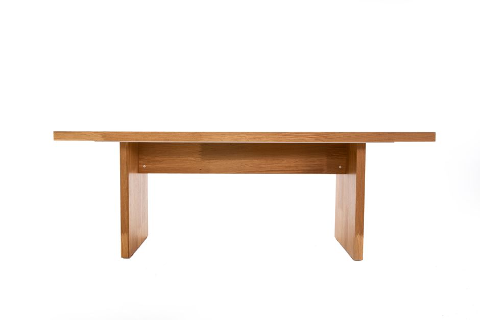 Simple wooden table with clean design against a white backdrop.