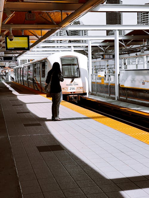 A Woman Standing at the Train Station