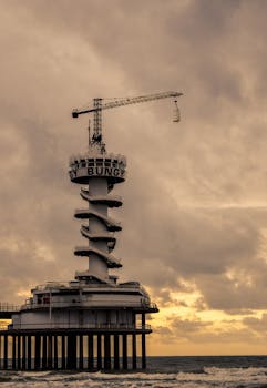 Dramatic capture of Scheveningen Pier amidst a moody sky over the North Sea.