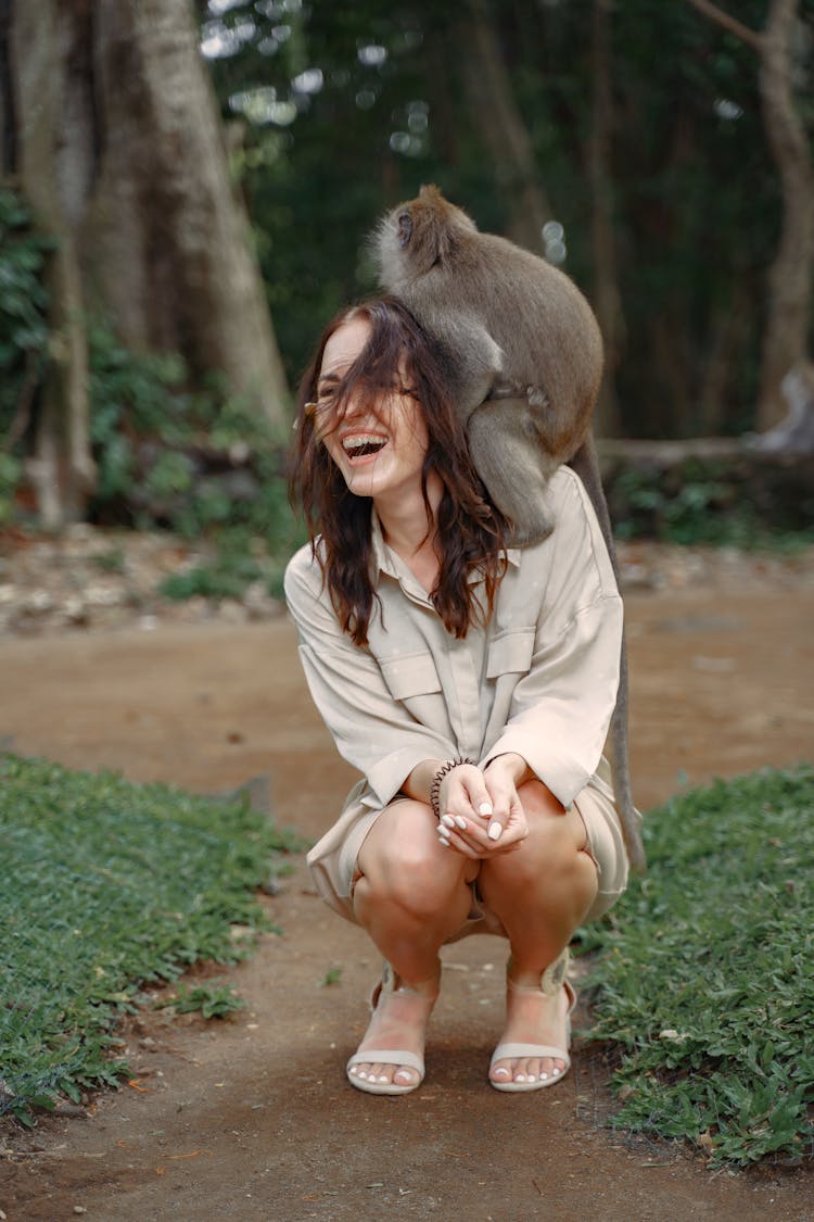 Cheerful Woman Having Monkey On Shoulder