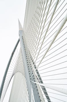 An architectural marvel showcasing geometric structure and steel cables set against a clear sky.
