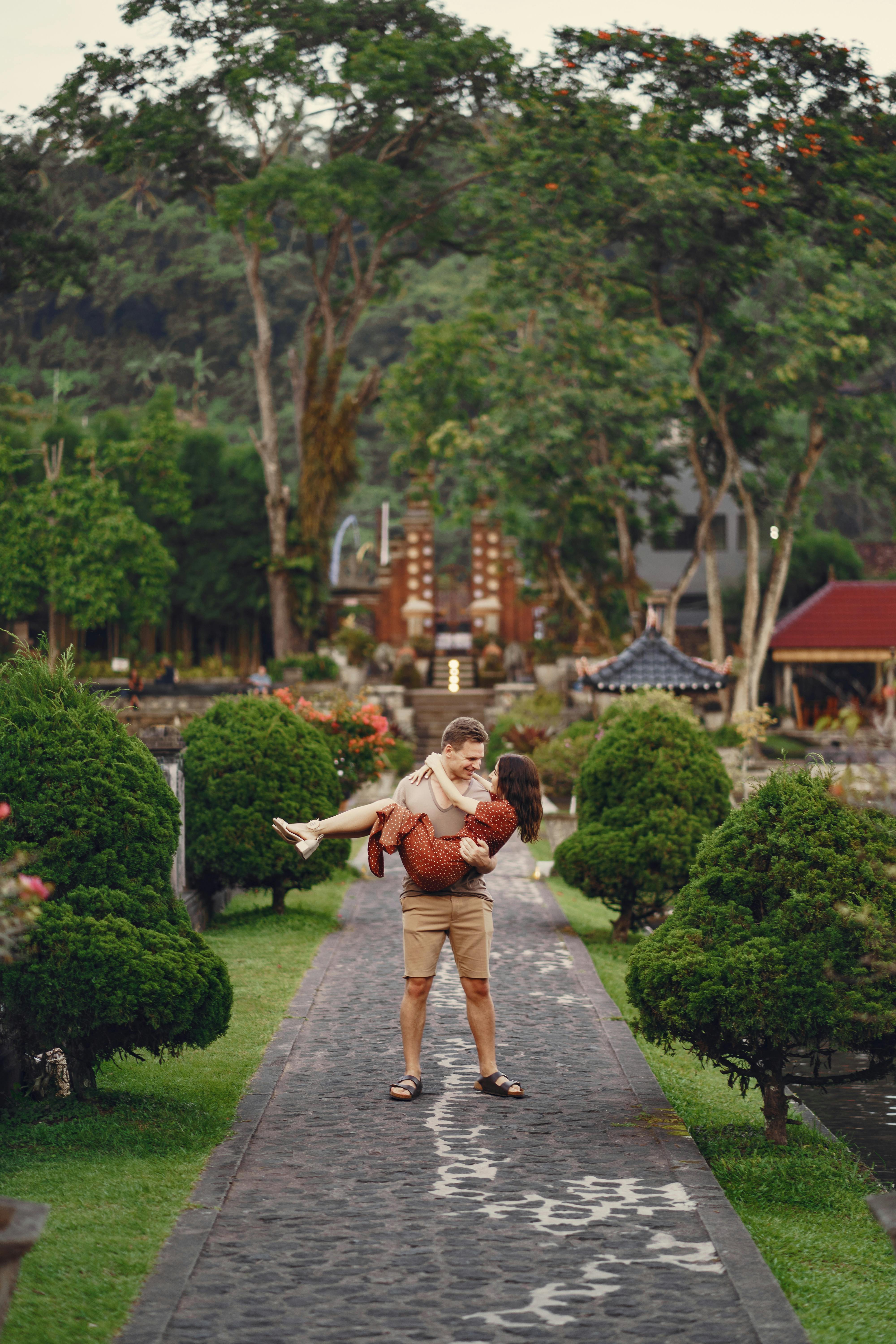 young couple walking in tropical garden