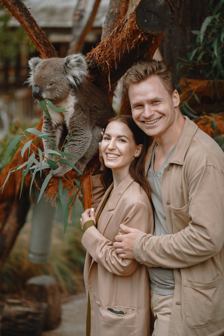 Happy Couple Standing Near Koala