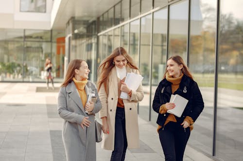 Free Smiling students discussing day in college Stock Photo