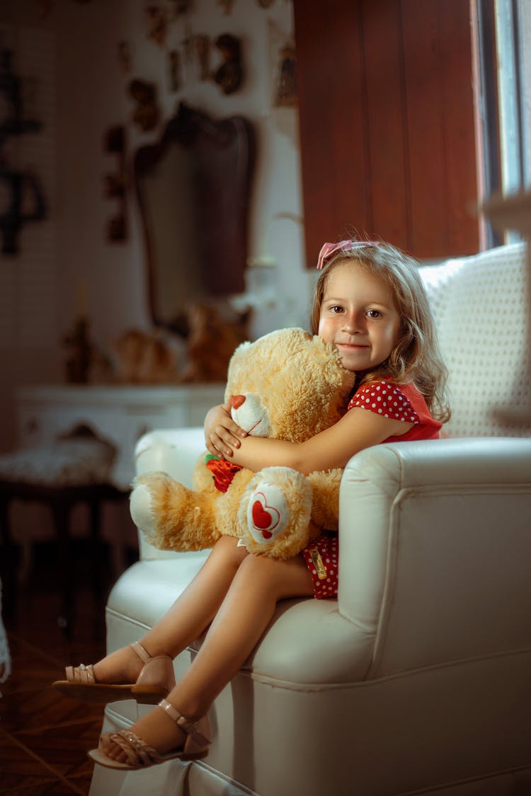 A Girl Hugging A Teddy Bear 