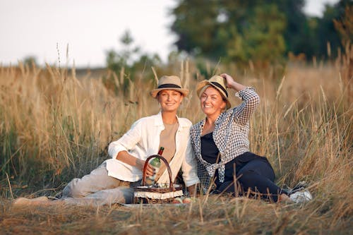 Happy women on picnic in middle of field