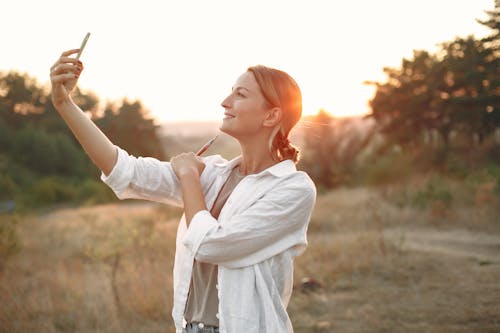 Free Happy woman taking selfie in nature Stock Photo