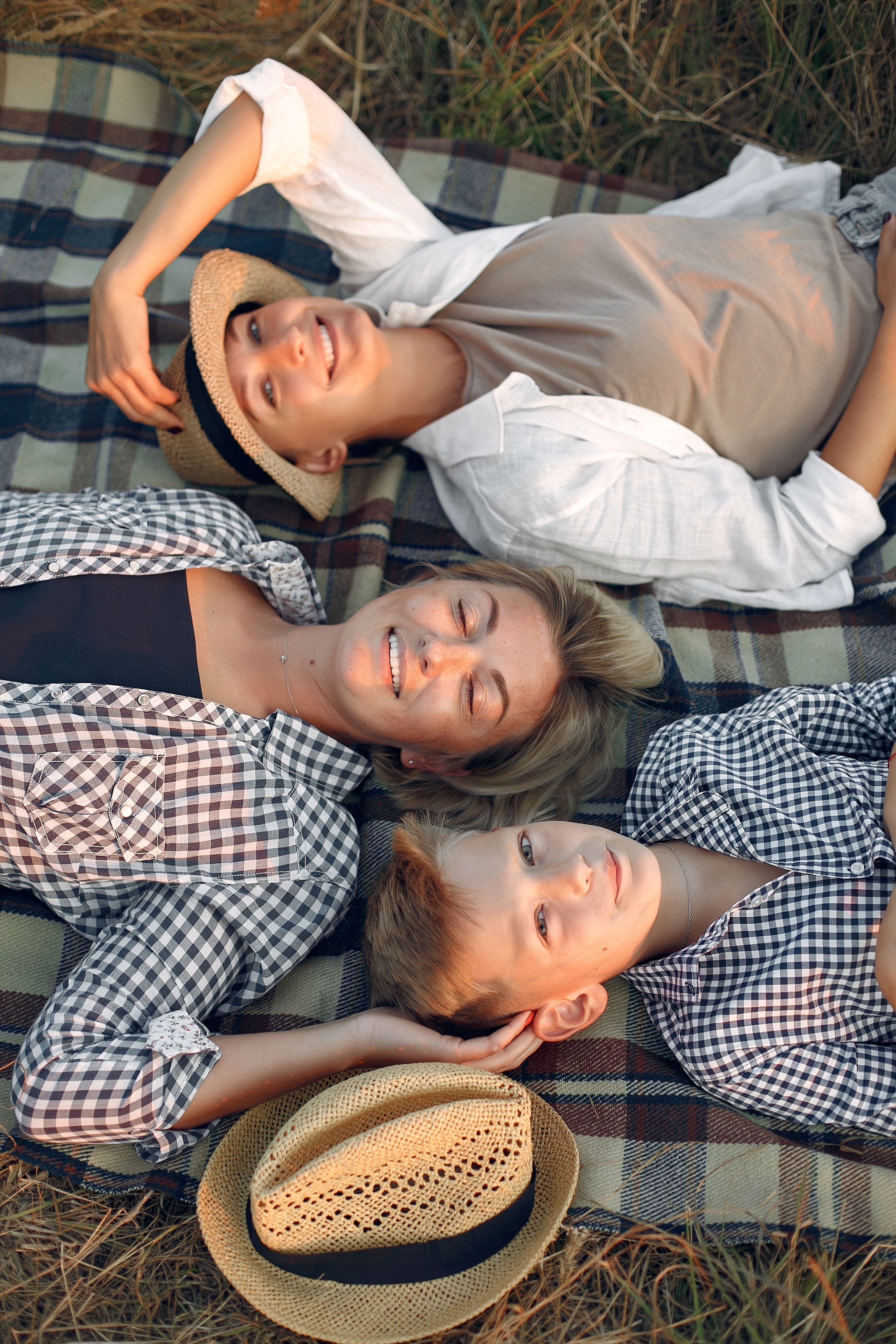Happy friends resting on picnic blanket · Free Stock Photo