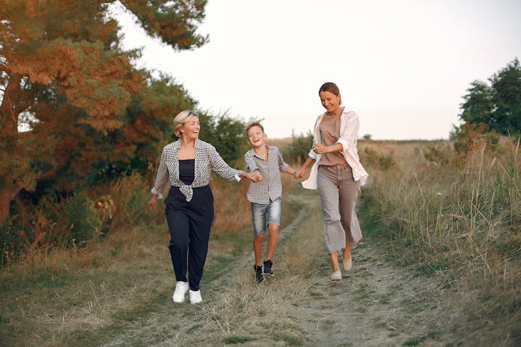 Happy Multi Generational Family Walking In Countryside
