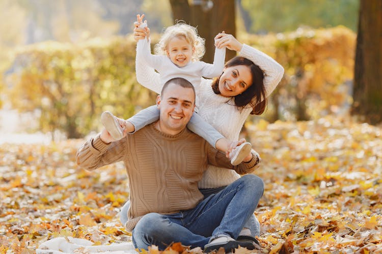 Cheerful Family Having Fun In Autumn Park