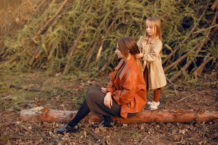 Content Girl Doing Hair For Mother