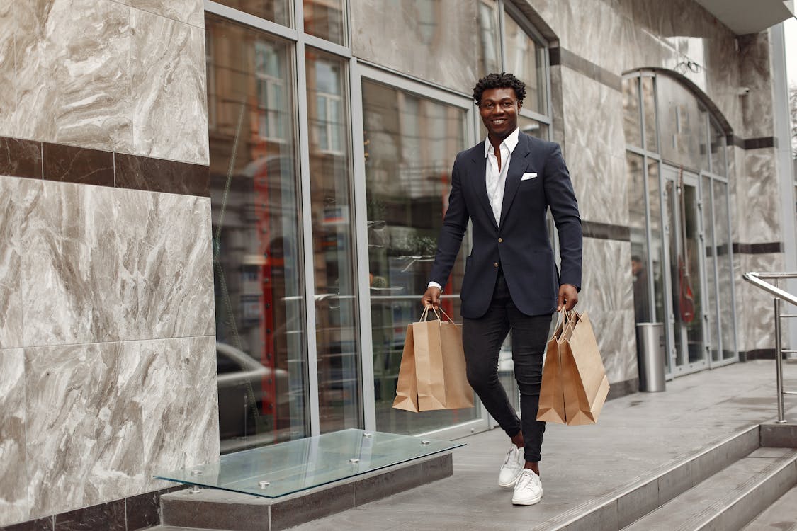 Elegant man walking with shopping bags