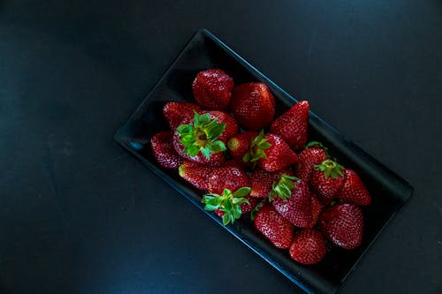 Plate of fresh strawberries in daylight