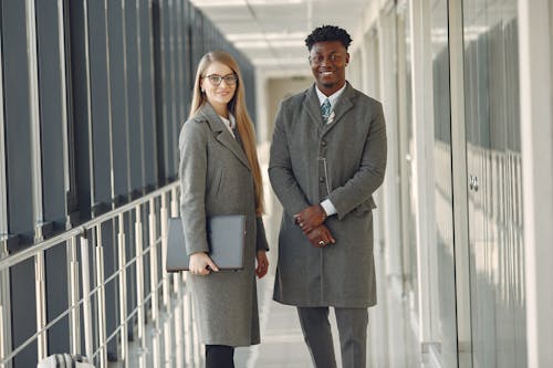 Confident business people in formal wear standing in hallway