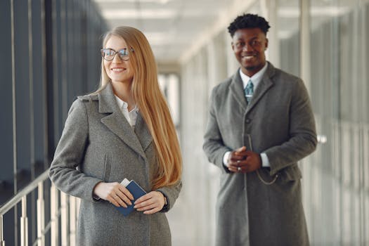 Professionals smiling in an airport terminal, ready for business travel.