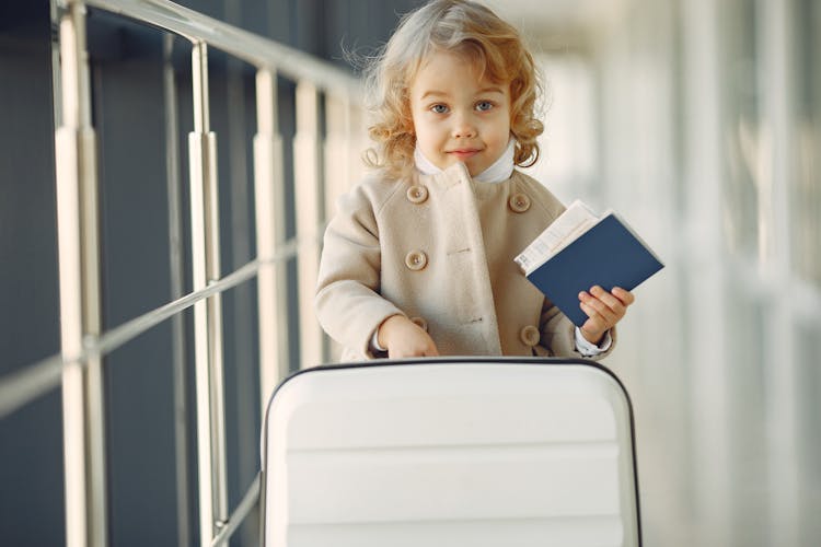 Cute Little Girl With Suitcase And Passport